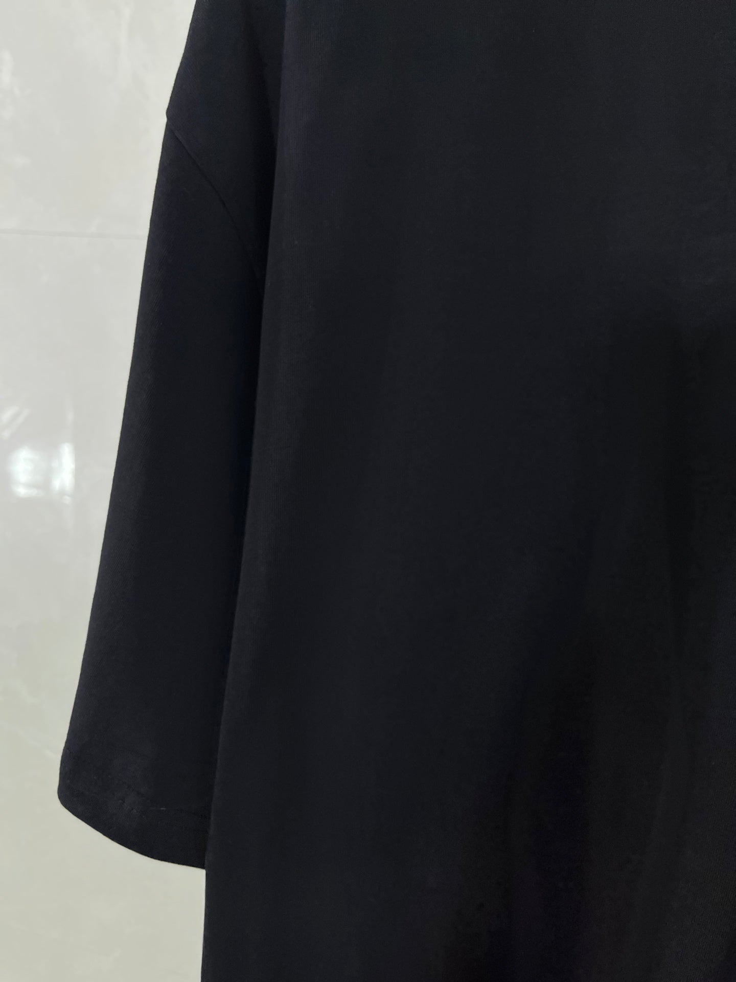 Balenciaga black short-sleeve T-shirt, draped side profile