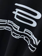 Balenciaga black graphic T-shirt close-up of white logo and text