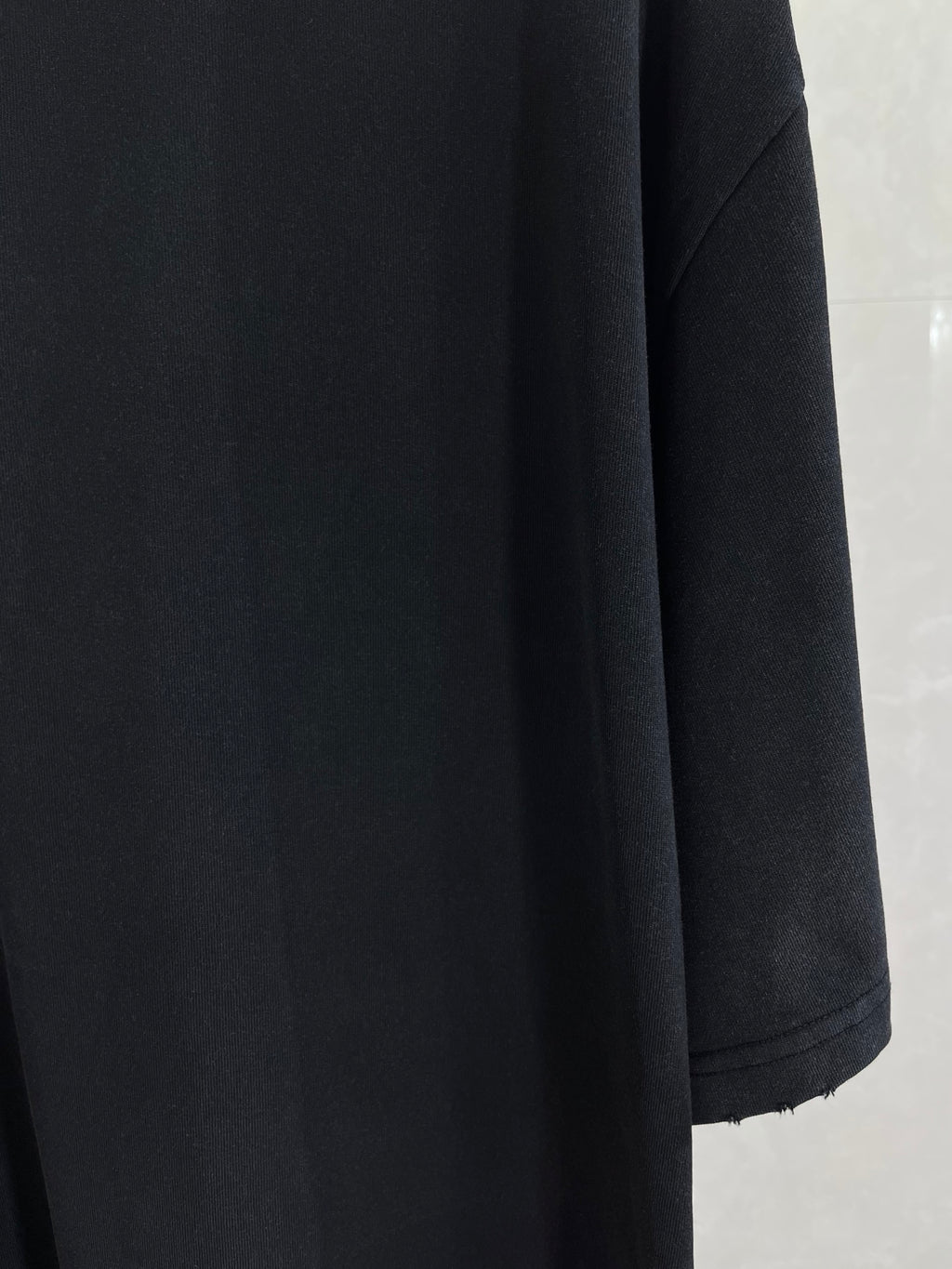 Balenciaga black short-sleeve top with structured shoulder and sleeve