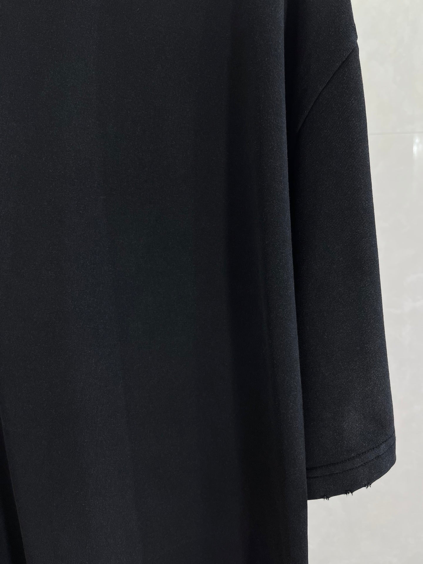 Balenciaga black short-sleeve top with structured shoulder and sleeve