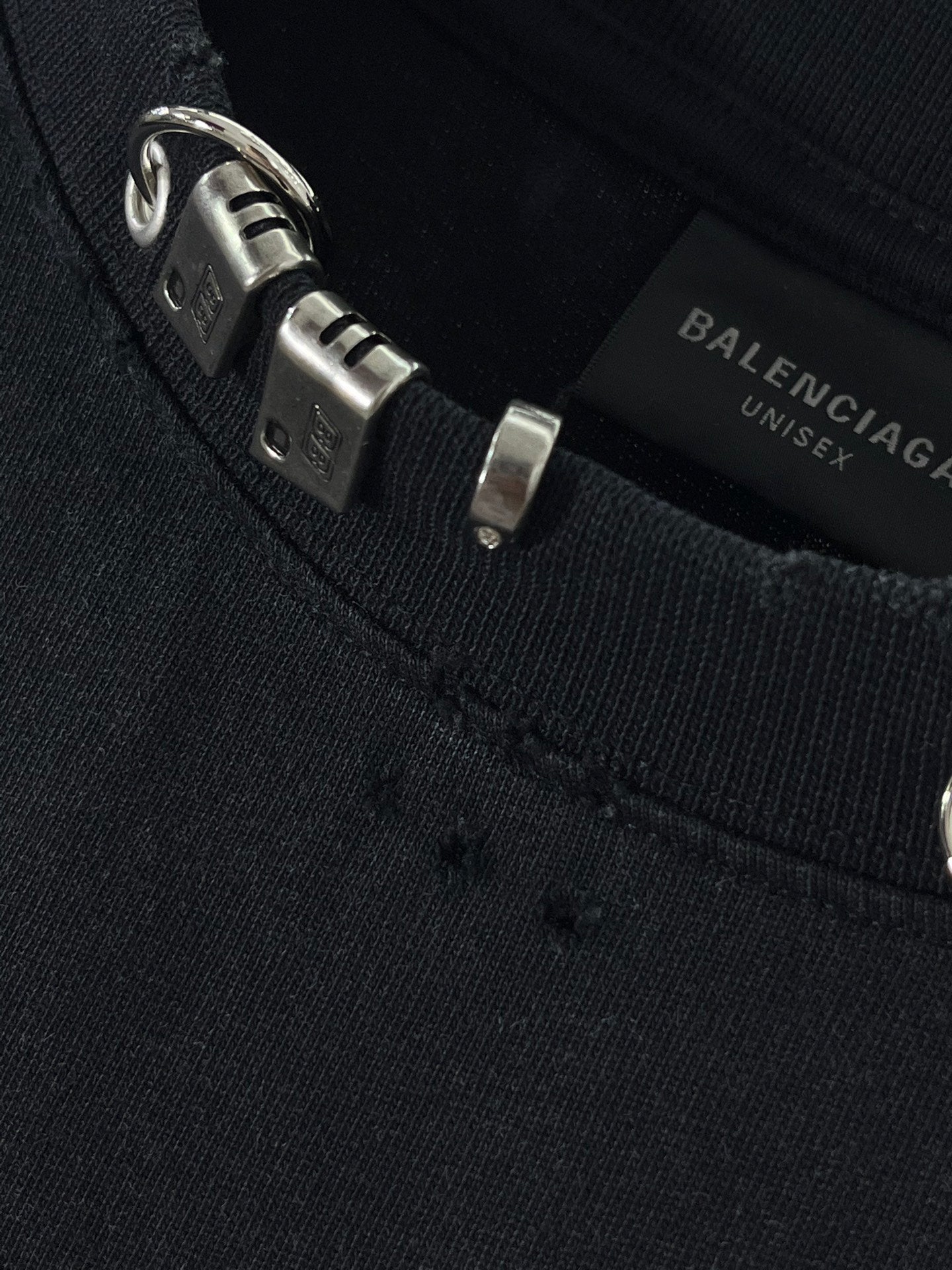 Balenciaga black crewneck top with metal tag and buckle hardware
