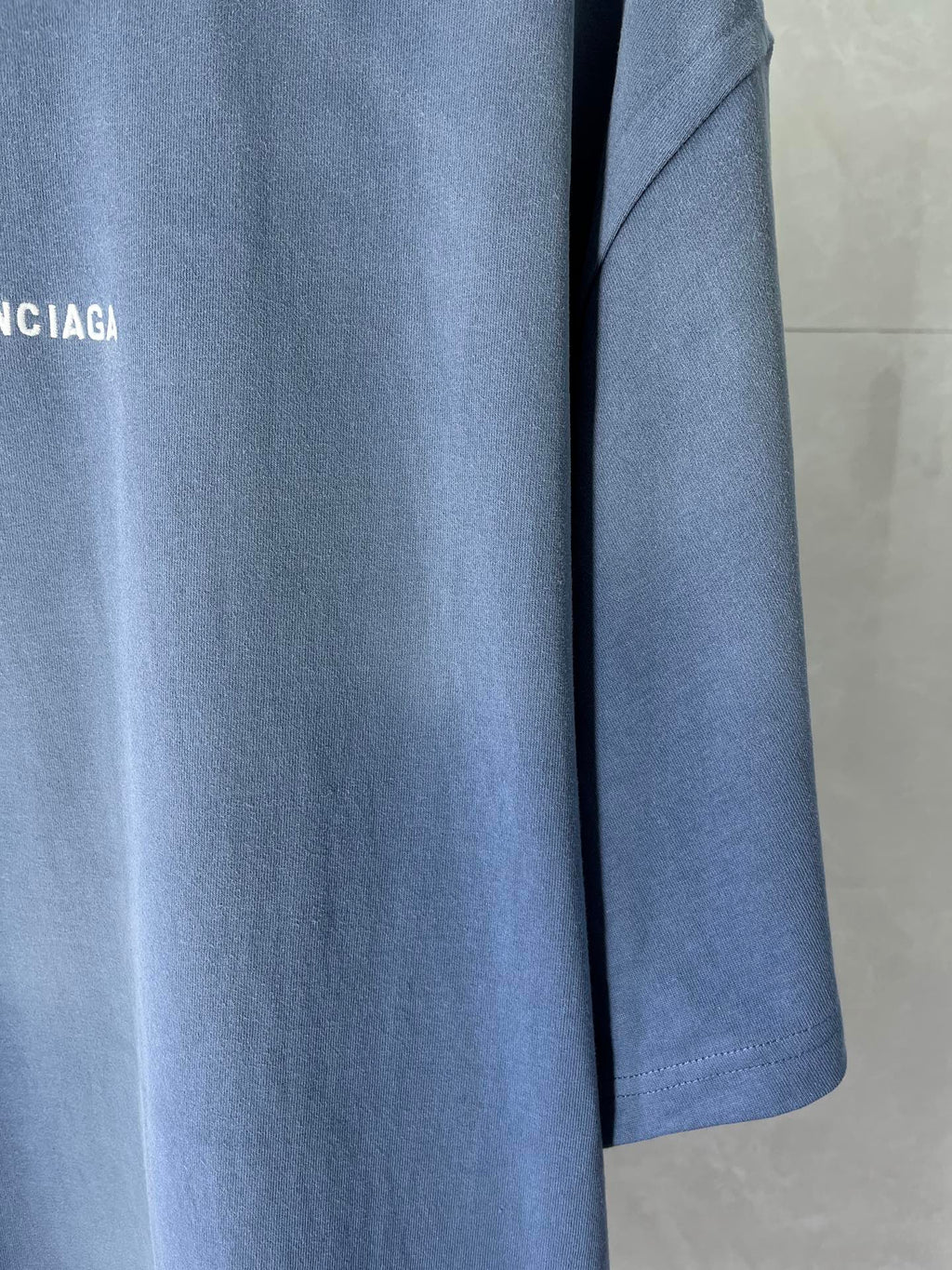 Balenciaga light blue T-shirt sleeve and hem detail with logo print
