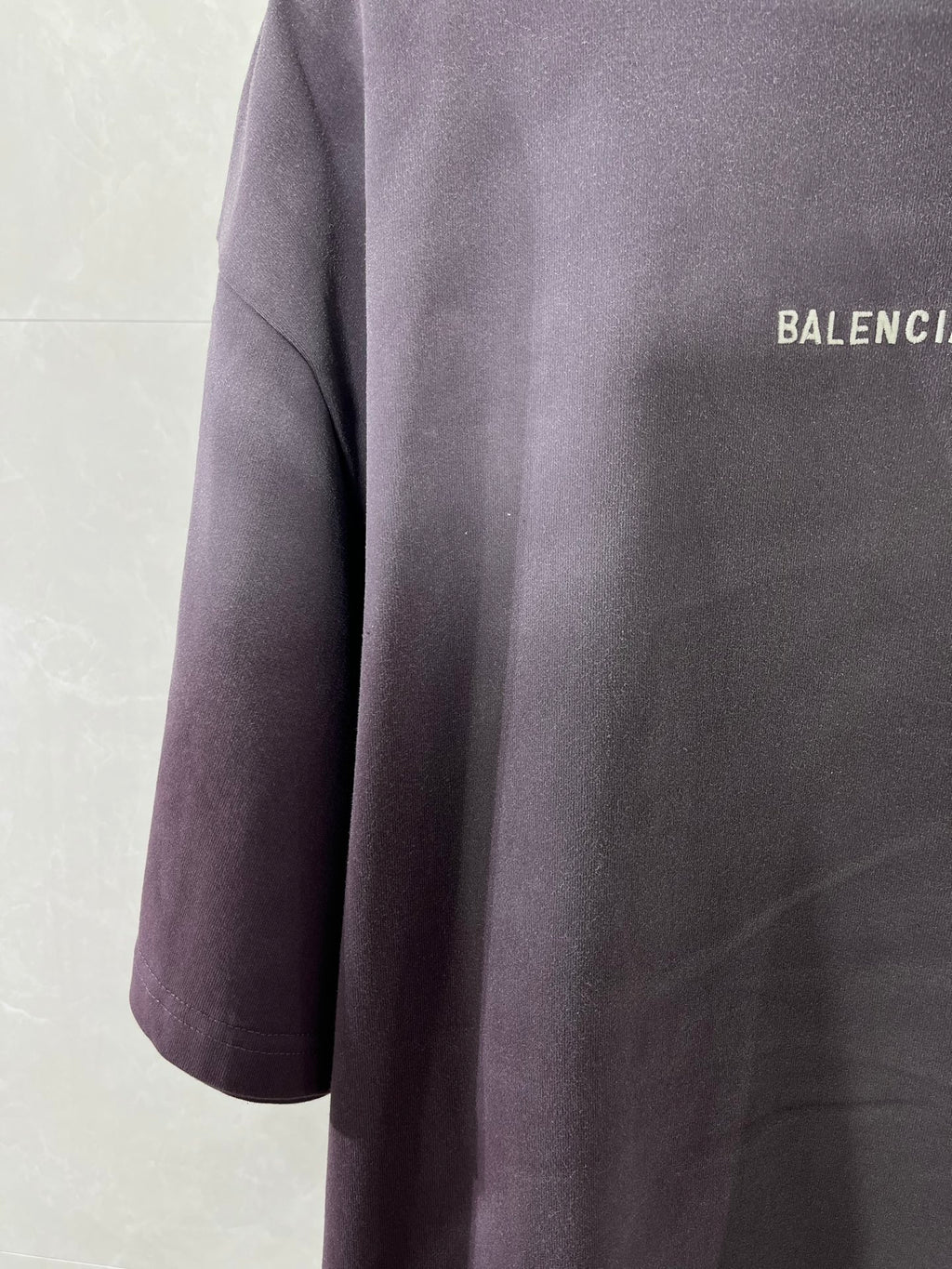 Balenciaga short-sleeve T-shirt, dark purple, side view with partial logo