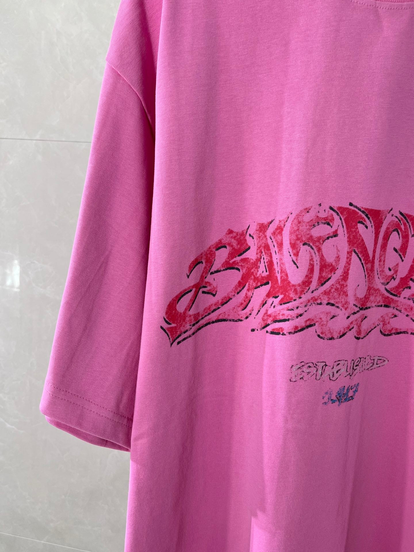Pink Balenciaga T-shirt with large red graphic print across the front