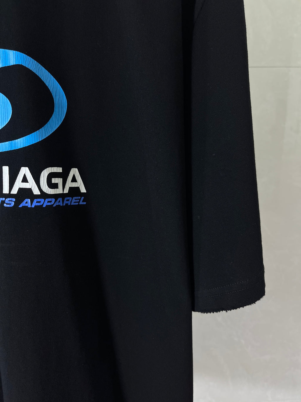 Black Balenciaga T-shirt with blue logo and white text on chest