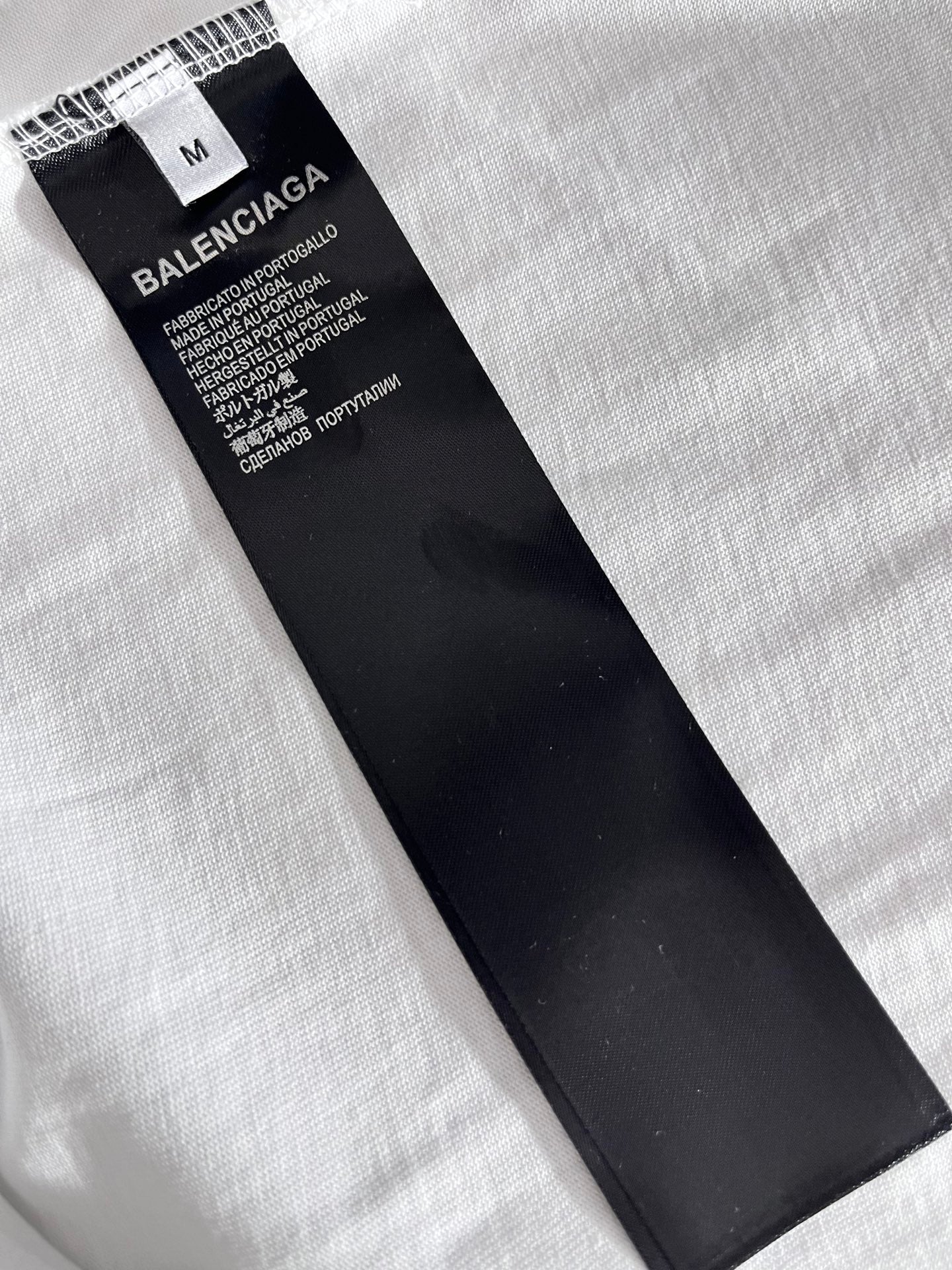 Balenciaga T-shirt with black neck label marked size M on white fabric