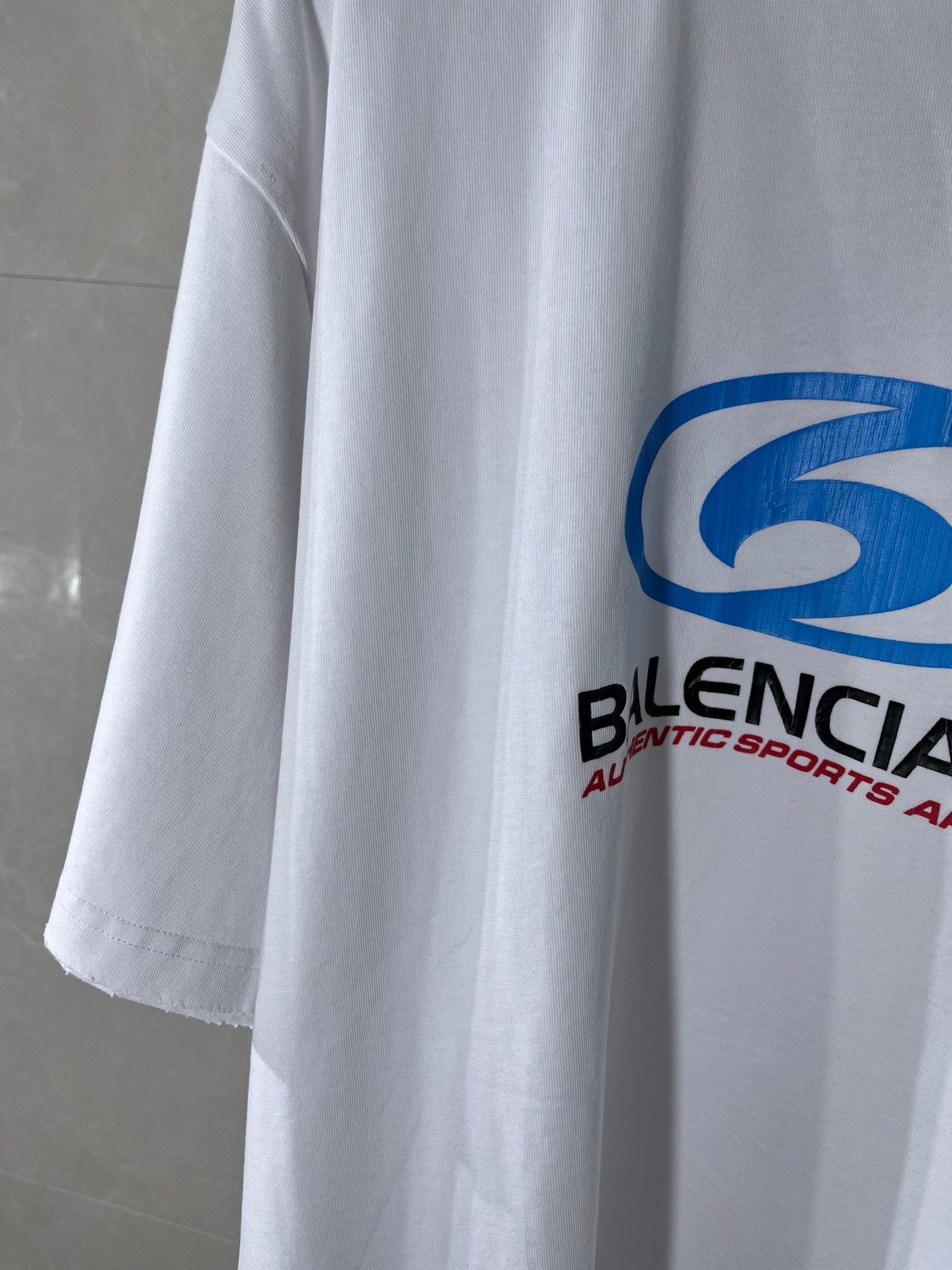 Balenciaga white T-shirt with partial blue logo and black brand text