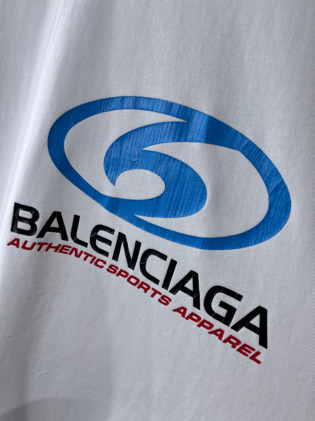 Balenciaga white T-shirt with large blue logo and red “Authentic sports apparel”
