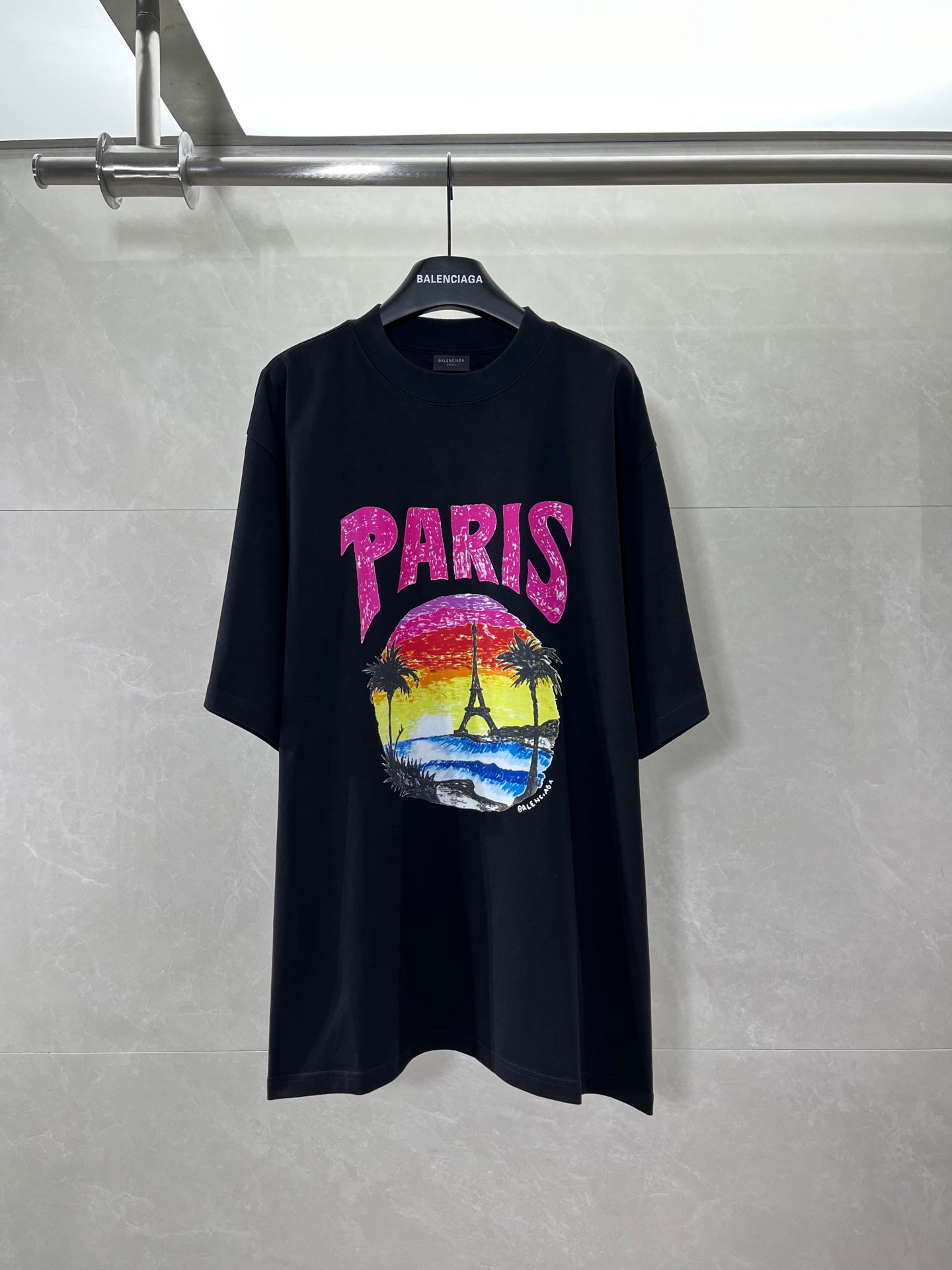 Balenciaga black T-shirt with pink PARIS logo and colorful beach graphic