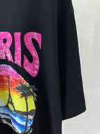 Balenciaga black T-shirt side view with partial pink letters and beach graphic
