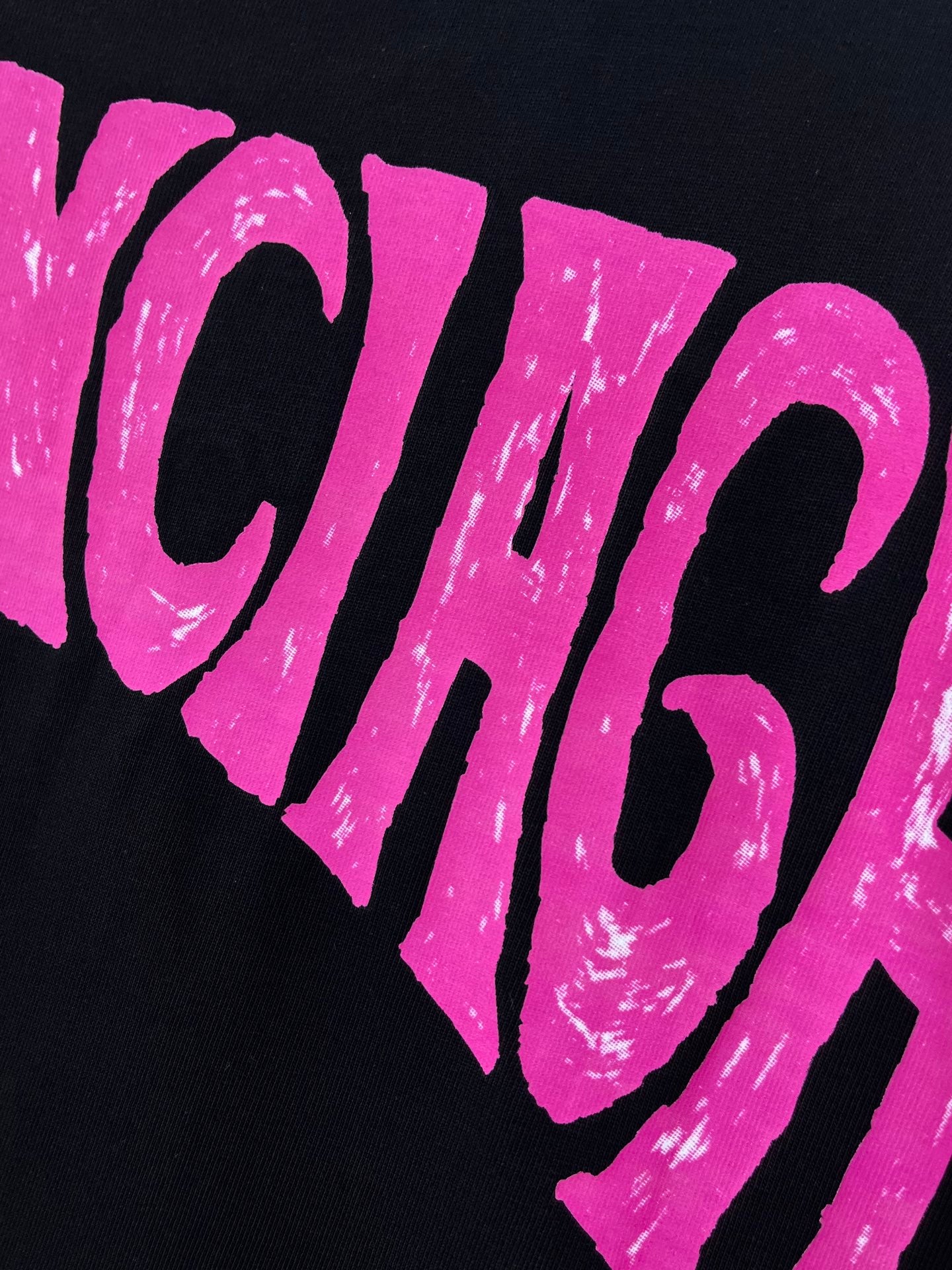 Balenciaga black T-shirt close-up of pink CHICAGO text graphic