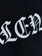 Balenciaga black T-shirt with cracked white lettering across the chest