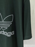 Dark green T-shirt front detail with white adidas trefoil and wordmark print