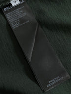 Dark green T-shirt with black fabric care label tag on inner seam