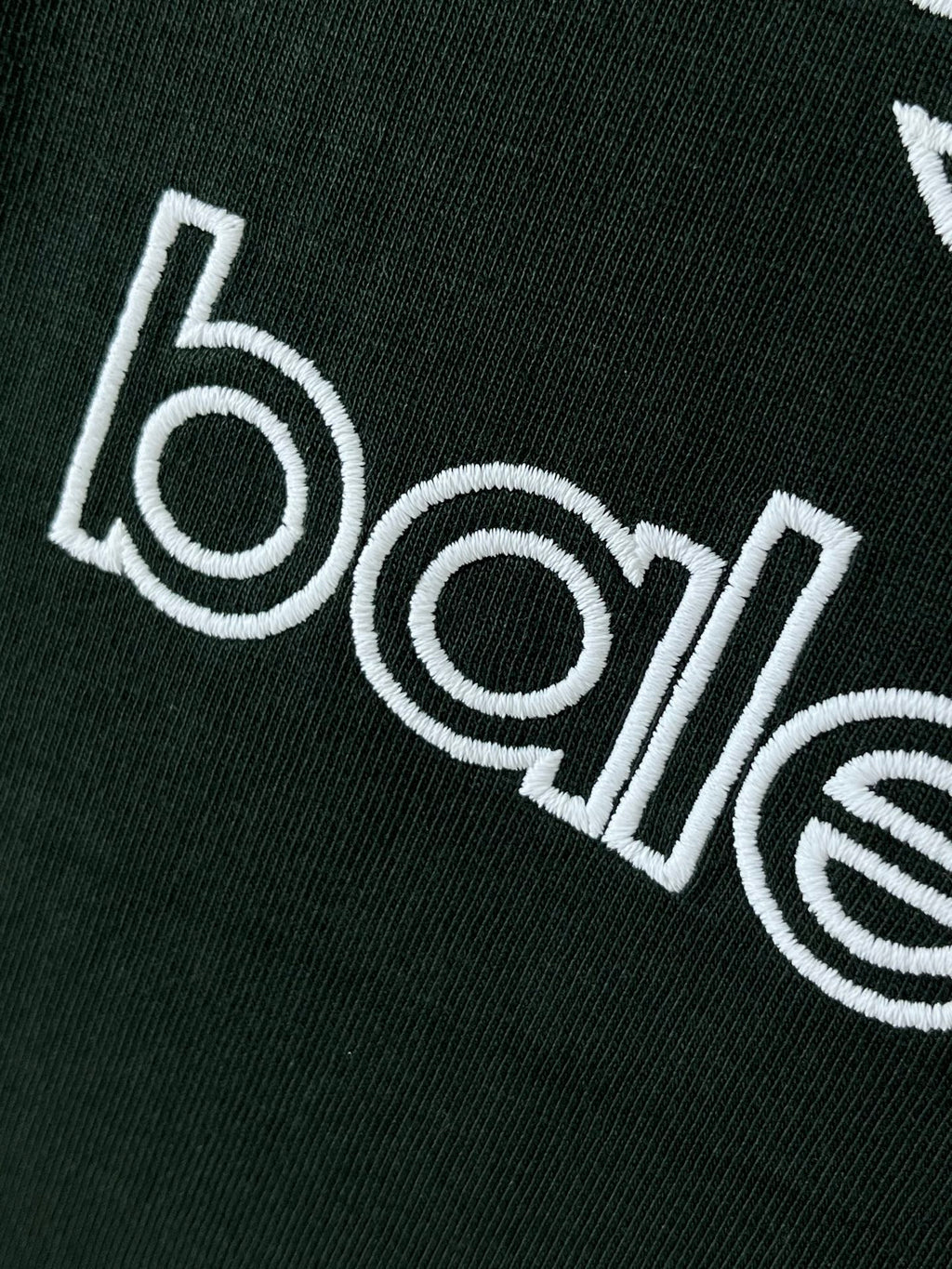 Dark green T-shirt wordmark graphic printed in white on fabric