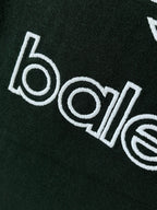 Dark green T-shirt wordmark graphic printed in white on fabric
