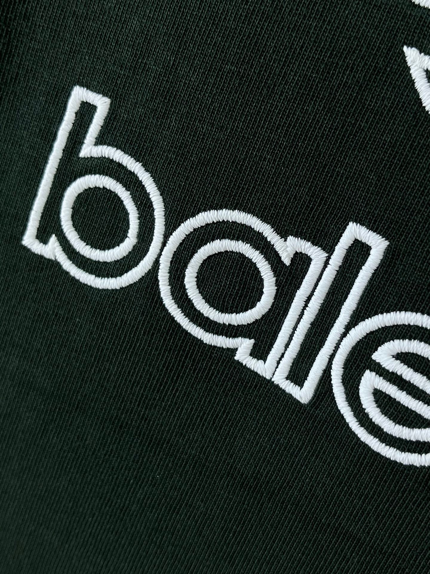 Dark green T-shirt wordmark graphic printed in white on fabric