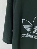 Dark green T-shirt sleeve with white adidas logo stripes graphic print