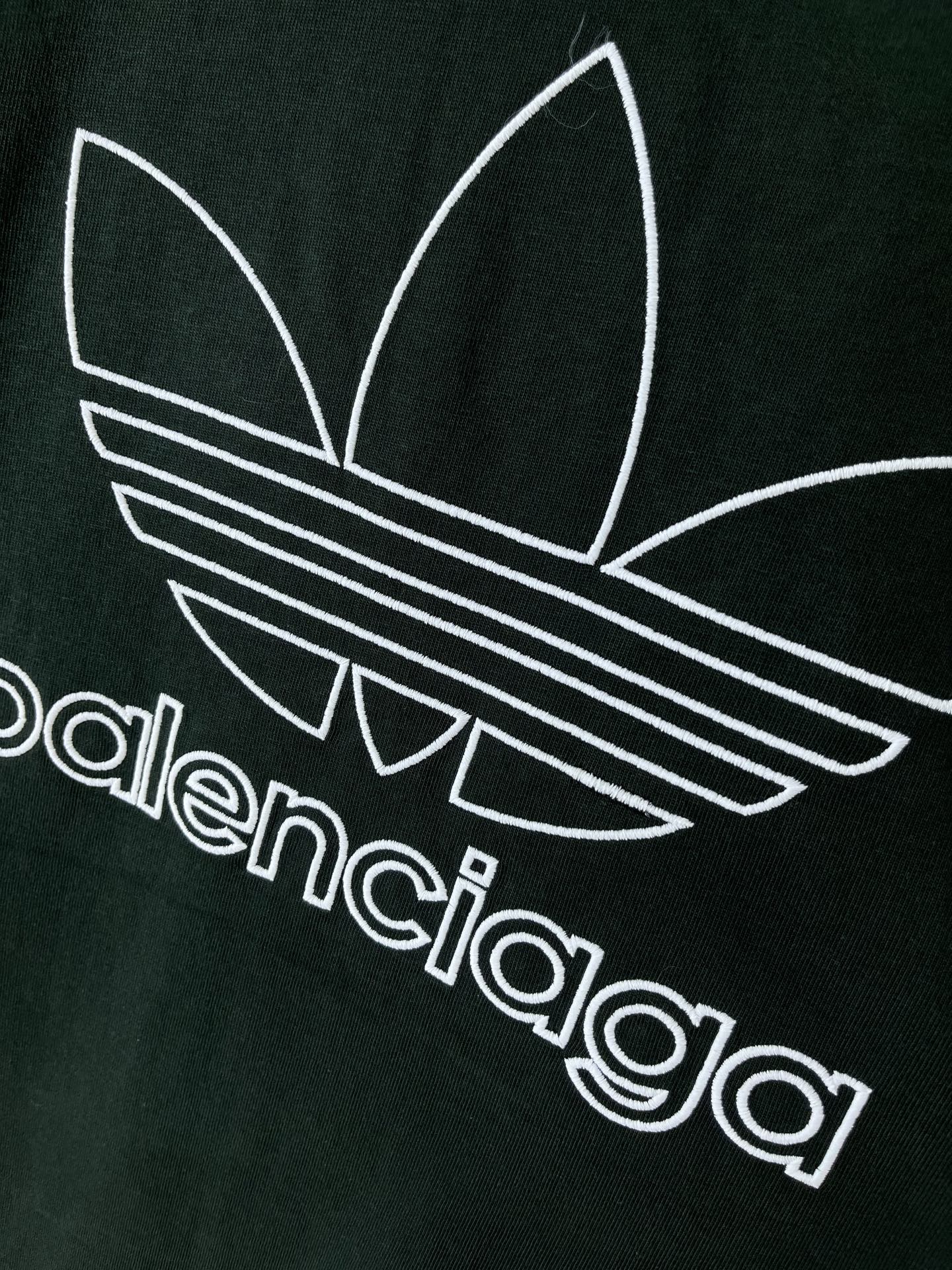 Dark green T-shirt chest graphic with adidas trefoil and striped logo in white