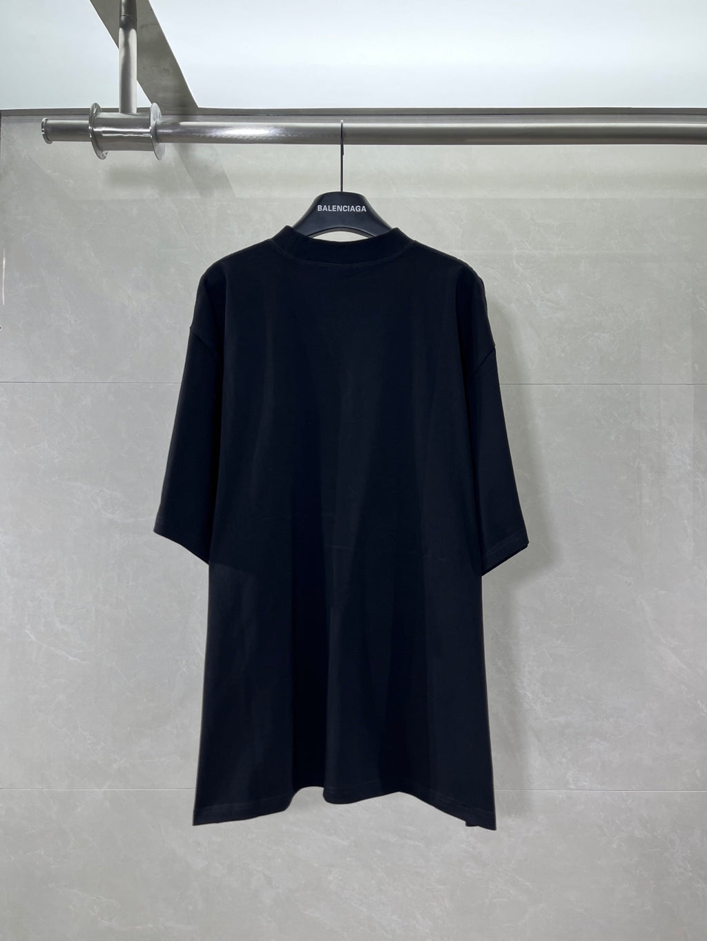 Balenciaga short-sleeve T-shirt in dark color, back view with centered logo tag
