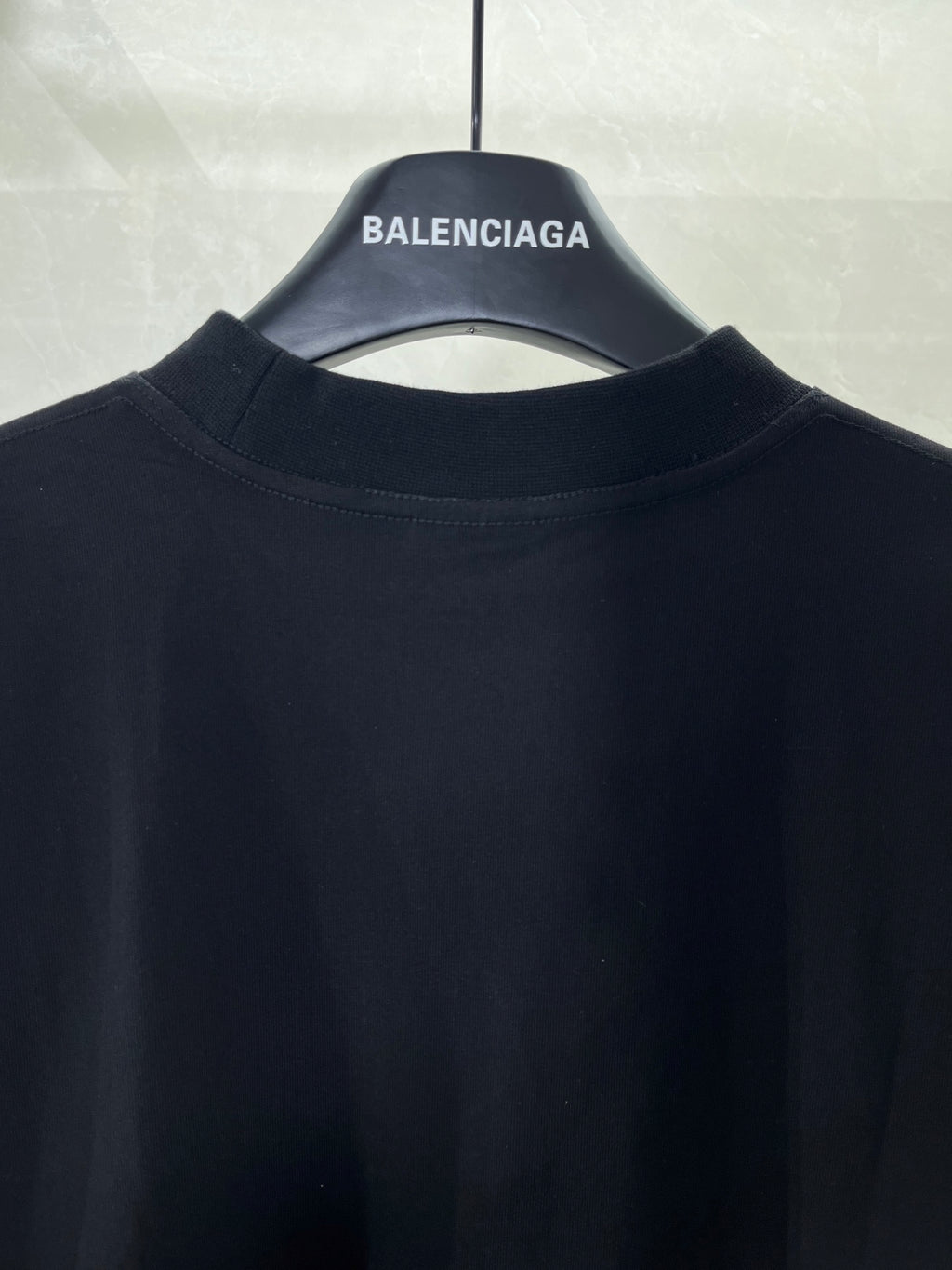 Balenciaga T-shirt collar and upper back area on dark fabric