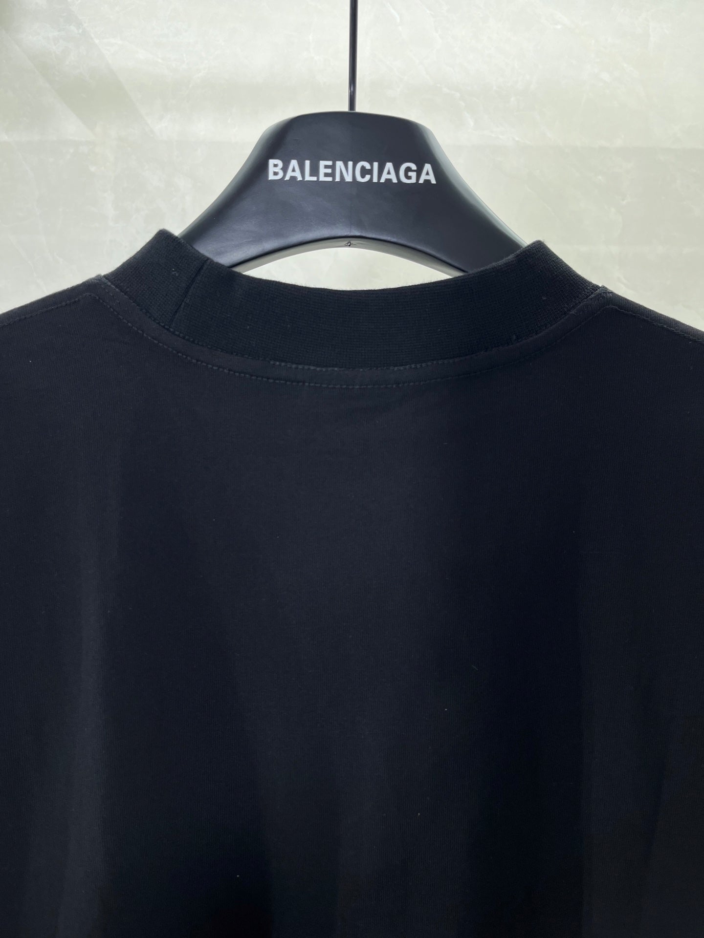 Balenciaga T-shirt collar and upper back area on dark fabric