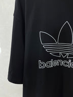 Balenciaga T-shirt with large white trefoil graphic and partial logo text on dark