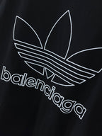 Balenciaga T-shirt front with white trefoil graphic and balenciaga lettering on dark