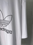White Balenciaga logo T-shirt, close-up of printed emblem and sleeve hem.