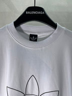 White Balenciaga graphic logo T-shirt, close-up of crew neck and logo on chest.