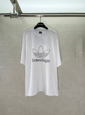 White Balenciaga graphic logo T-shirt with large trefoil-style emblem on chest.