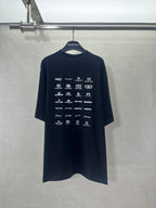 Dark crew-neck T-shirt with short sleeves and repeating Balenciaga logo graphics