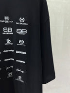 Dark T-shirt with repeating Balenciaga logo prints, close-up