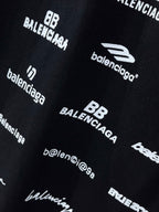 Dark T-shirt fabric close-up with Balenciaga and HLECHIUM graphics