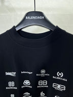 Dark crew-neck T-shirt neckline with Balenciaga hanger and logo print close-up