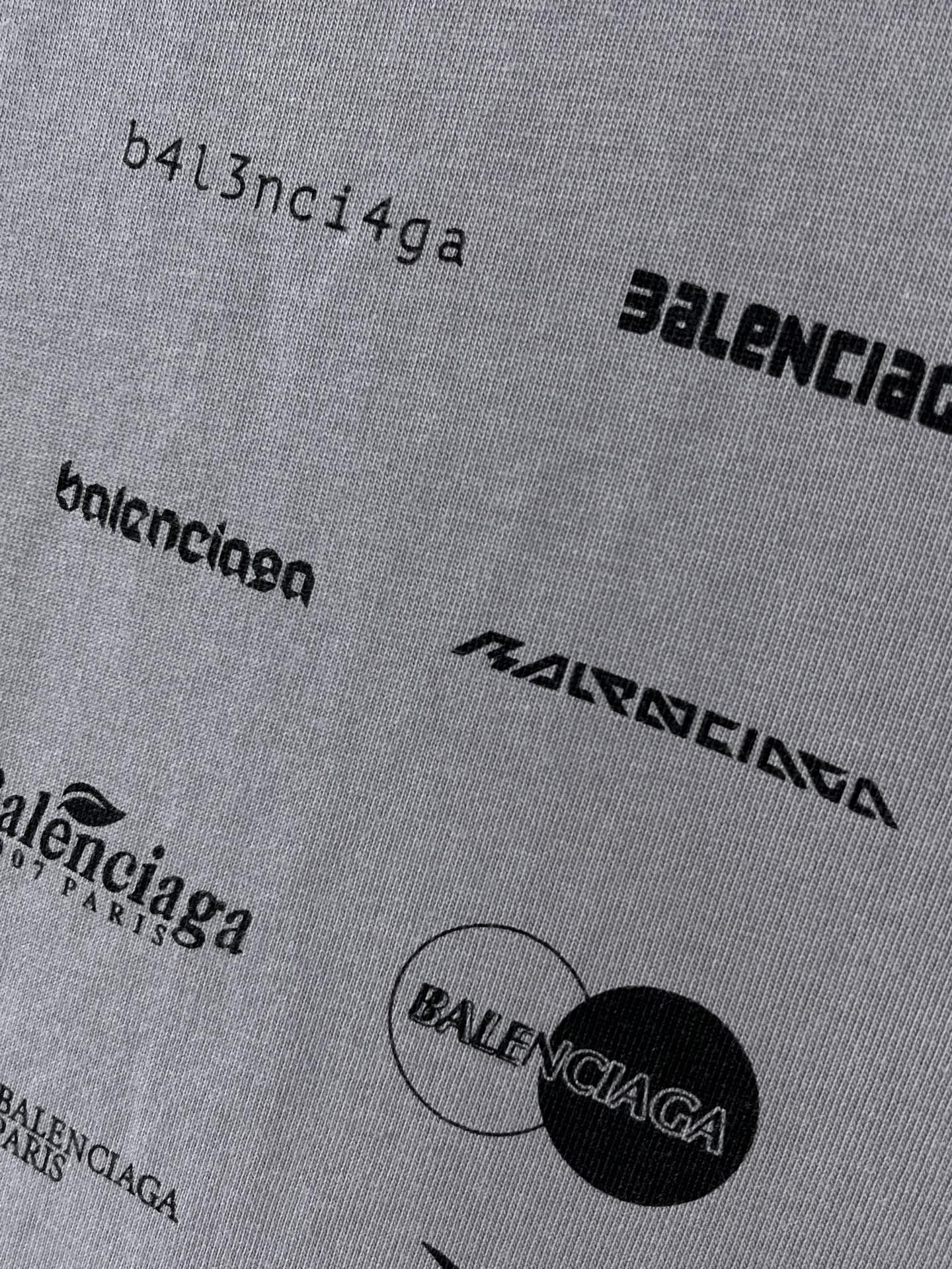 Balenciaga T-shirt fabric close-up with small logo text and circular graphic