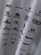 Balenciaga T-shirt fabric close-up showing multiple black logo prints