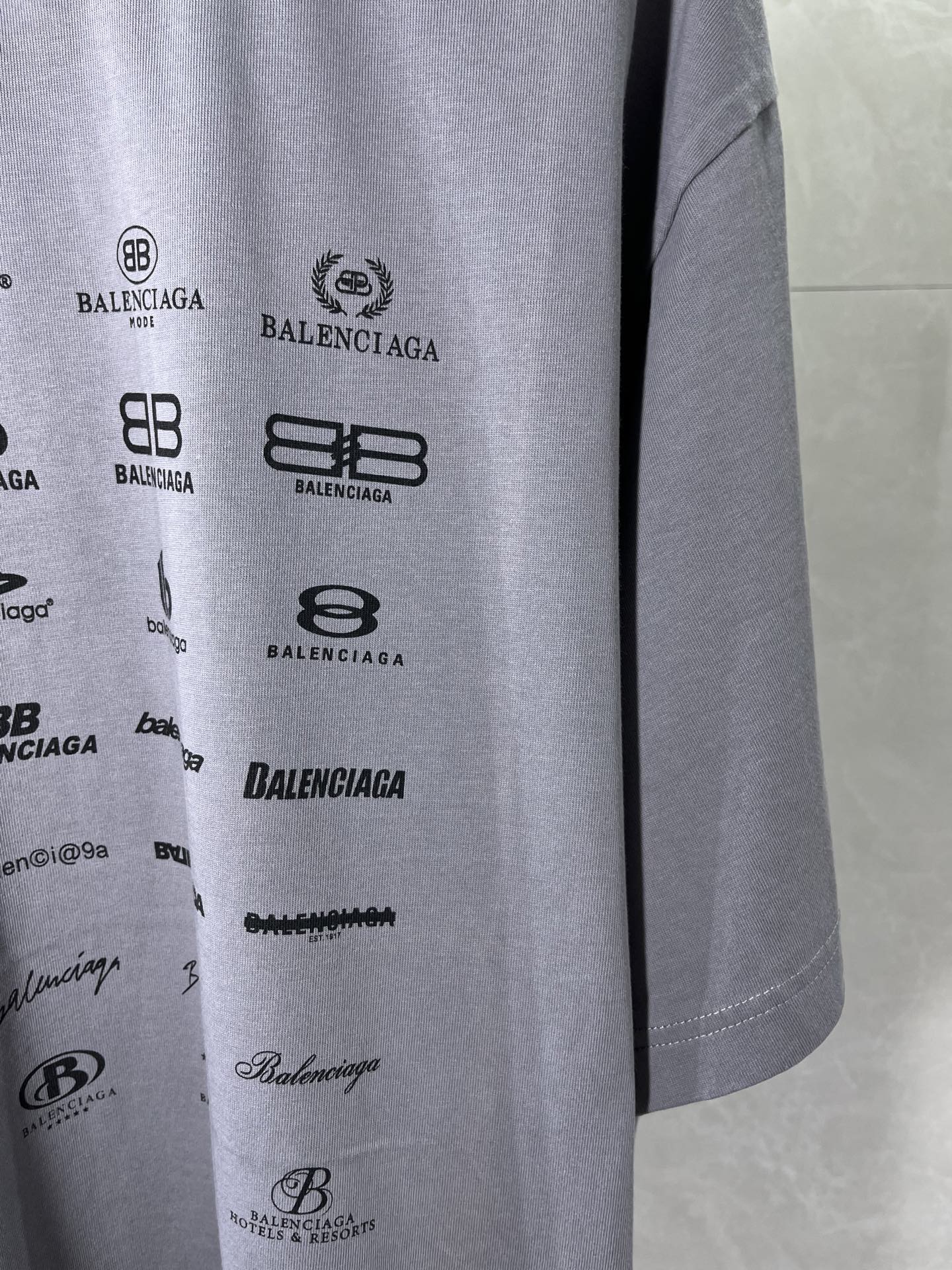 Balenciaga T-shirt fabric close-up with stacked logo graphics