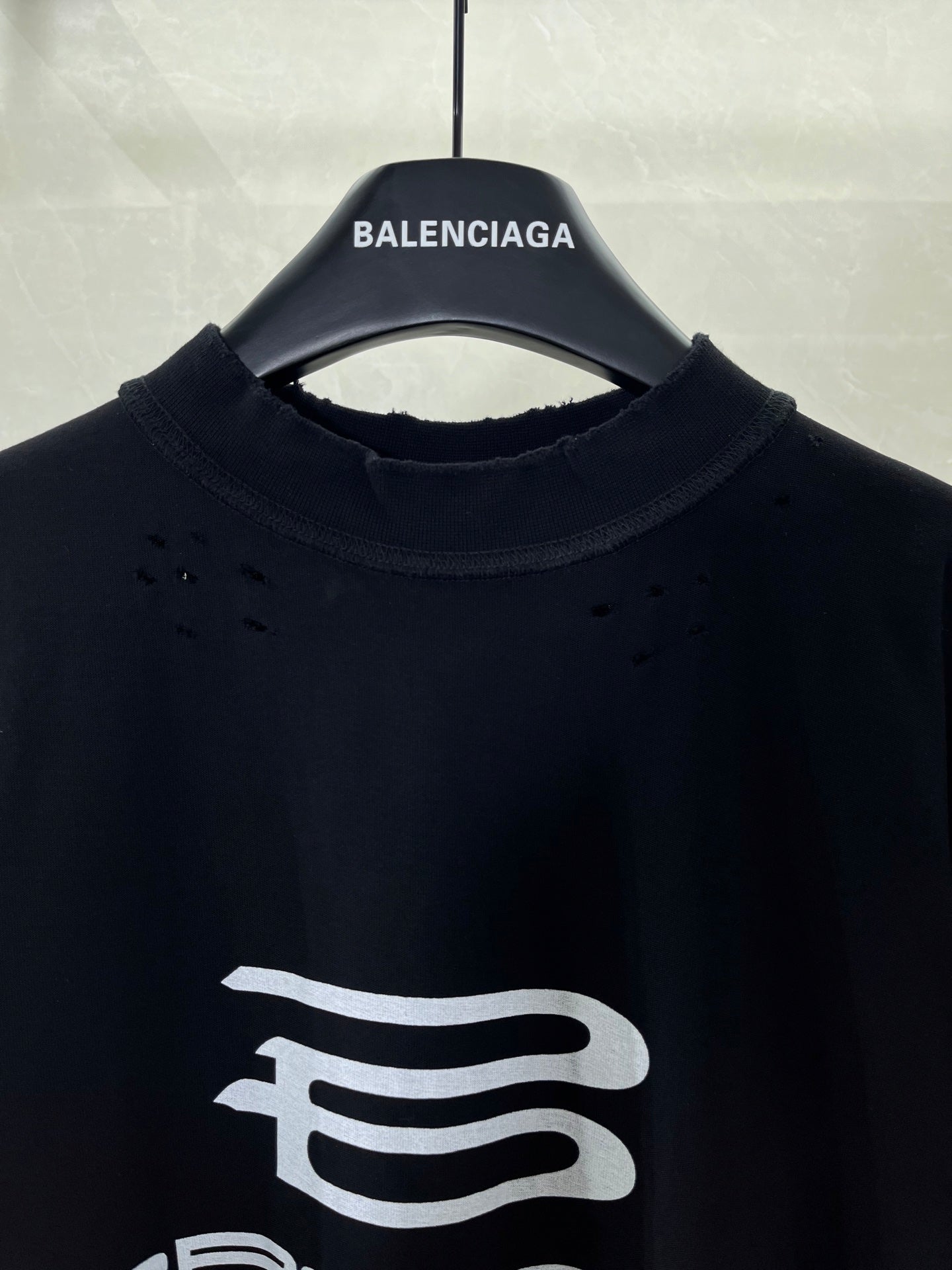 Balenciaga black graphic T-shirt close-up of crew neck and front logo print