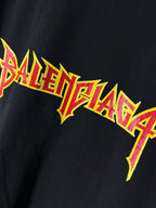 Short-sleeve T-shirt close-up of Balenciaga logo graphic on chest, dark fabric