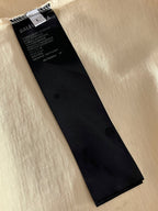Balenciaga black clothing label tag on cream fabric