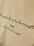 Balenciaga cream T-shirt close-up of cursive and small text graphic