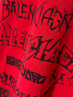 Red T-shirt fabric close-up with black graphic typography