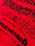 Red T-shirt close-up with black graffiti-style lettering pattern