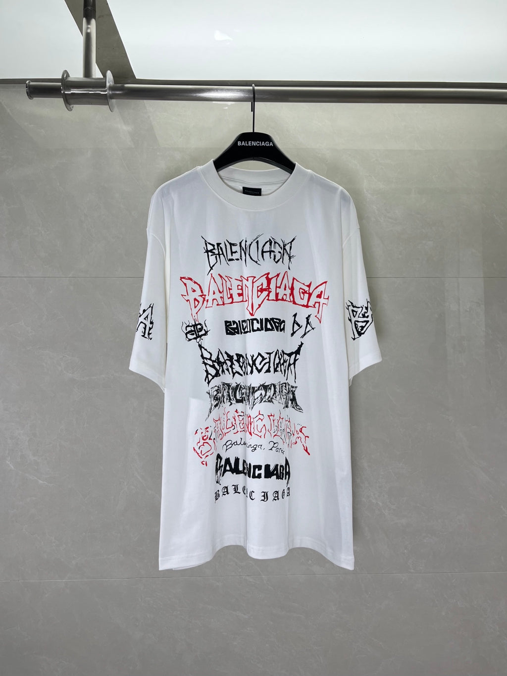 White graphic T-shirt with Balenciaga logo print on front, crew neck and short sleeves