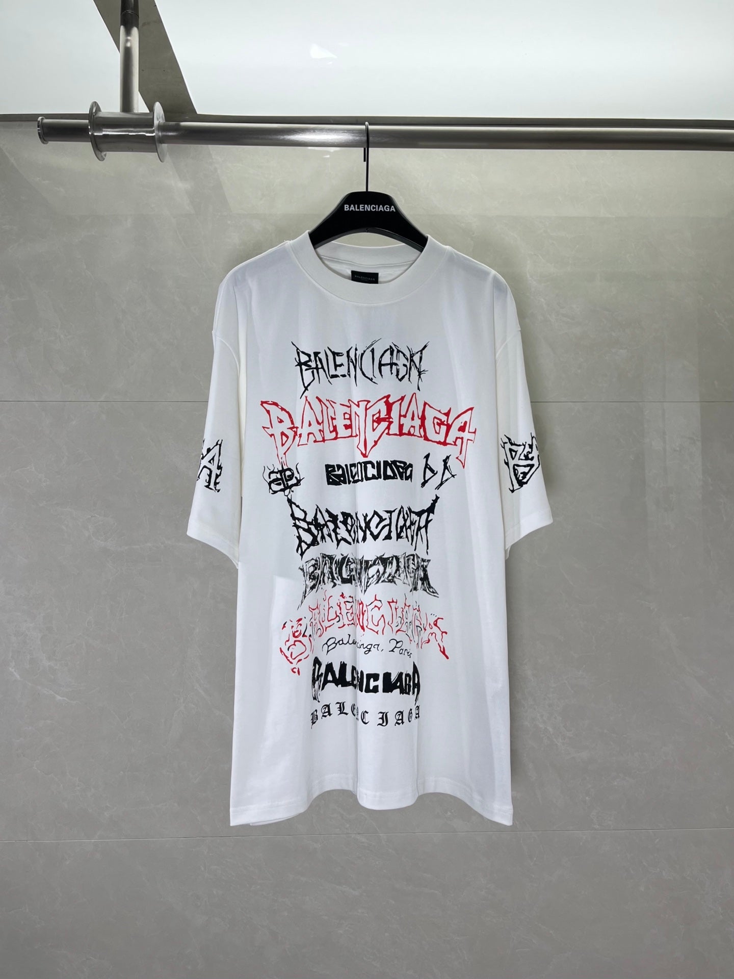 White graphic T-shirt with Balenciaga logo print on front, crew neck and short sleeves