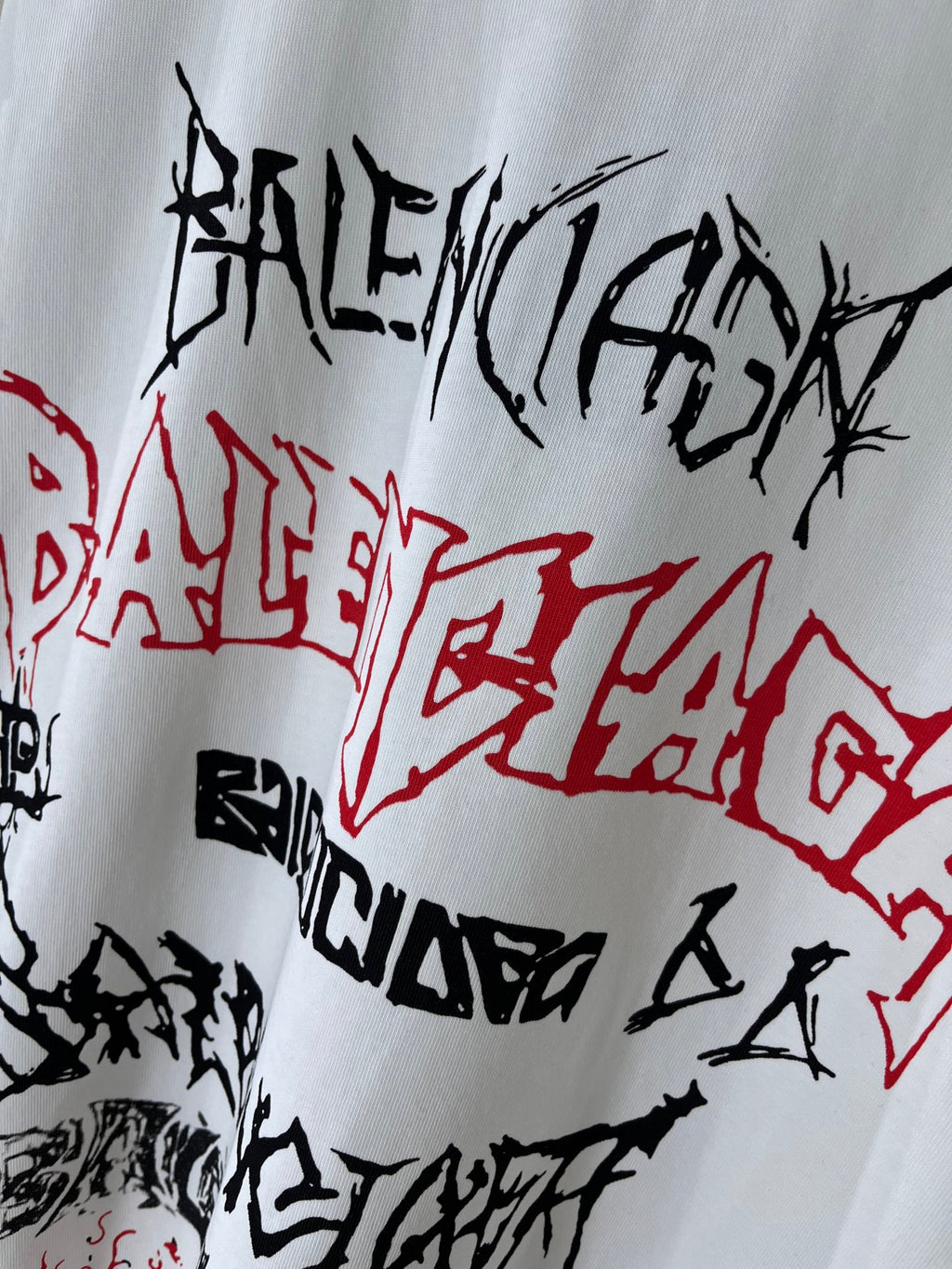 White T-shirt front close-up with black and red graffiti-style lettering