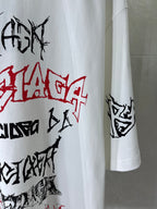 White T-shirt sleeve with black and red graffiti-style print, side view