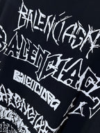 Balenciaga T-shirt graphic close-up, black fabric with dense white typographic text
