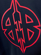 Close-up of large red emblem graphic on dark navy T-shirt.